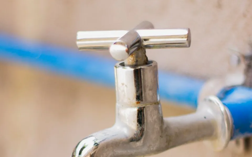 Close-up of a tap connected to supply pipework